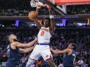 New York Knicks forward OG Anuoby dunks a basketball.