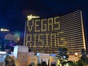 The Wynn and Encore Casinos in Las Vegas with rooms lit in the shape of a heart and the phrase "VEGAS RISING"